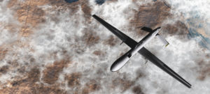Predator Drone from above, flying over clouds and dessert
