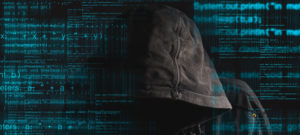 Faceless hooded anonymous computer hacker