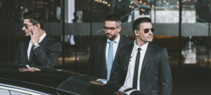 bodyguards going with businessman and reviewing territory near car