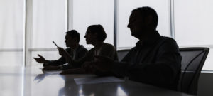 Silhouette of business people negotiating at meeting table
