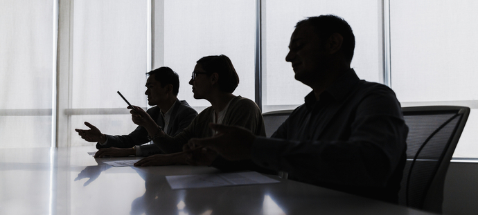 Silhouette of business people negotiating at meeting table