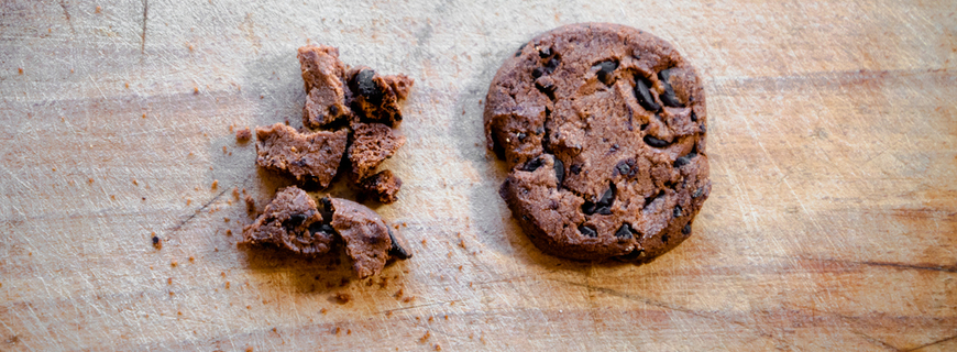 Broken chocolate chip cookies. Cookies broken in pieces with crumbs