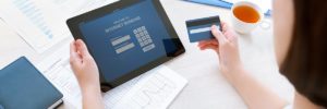 Businesswoman using a credit card for online internet banking